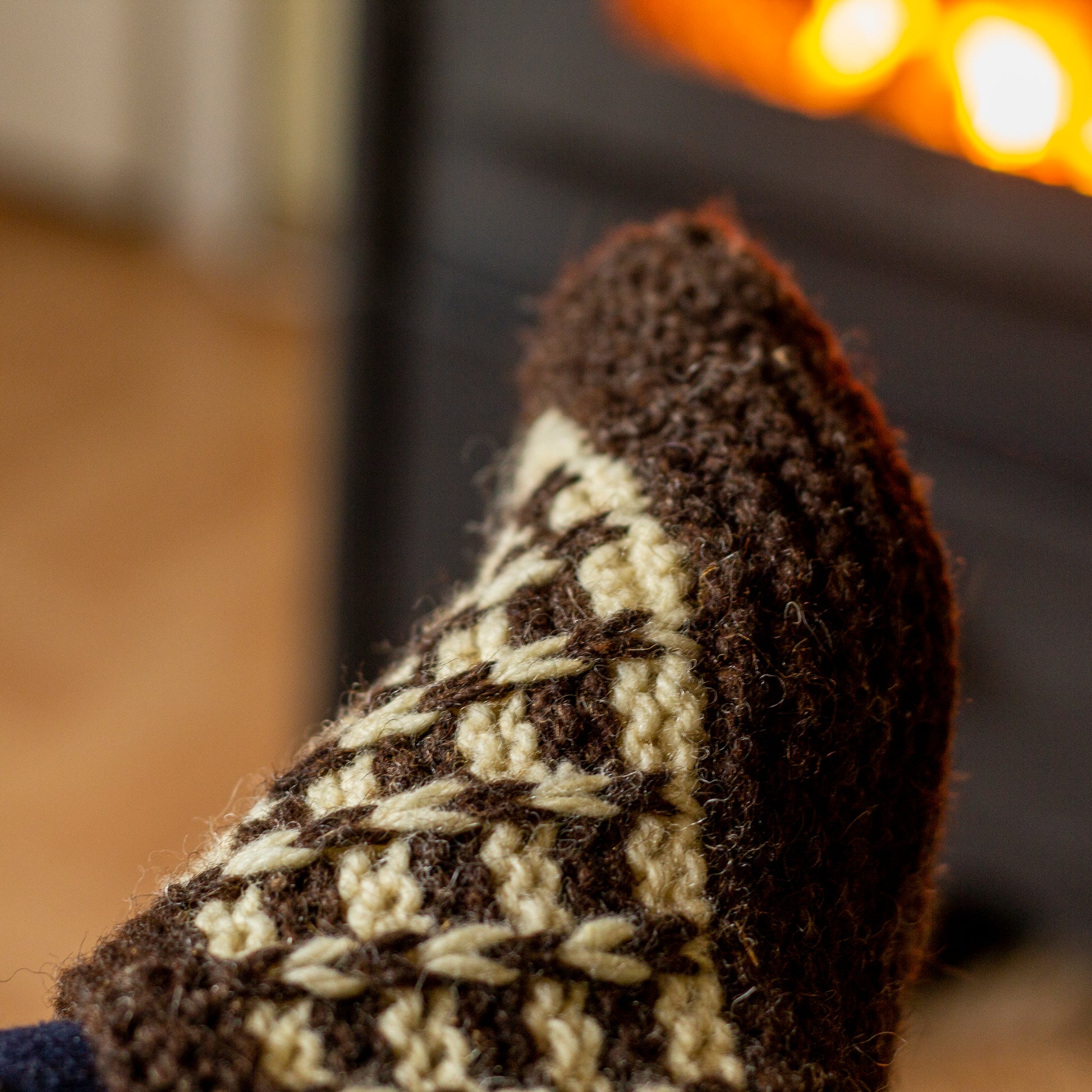 Close-up showing the detailed texture of knitted wool slippers.